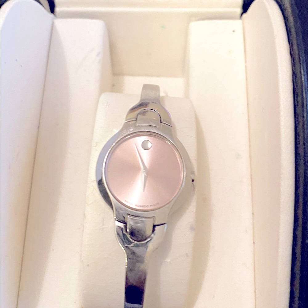 Movado Bracelet Watch with pink face. Band shows normal wear. Authentic- 1 owner